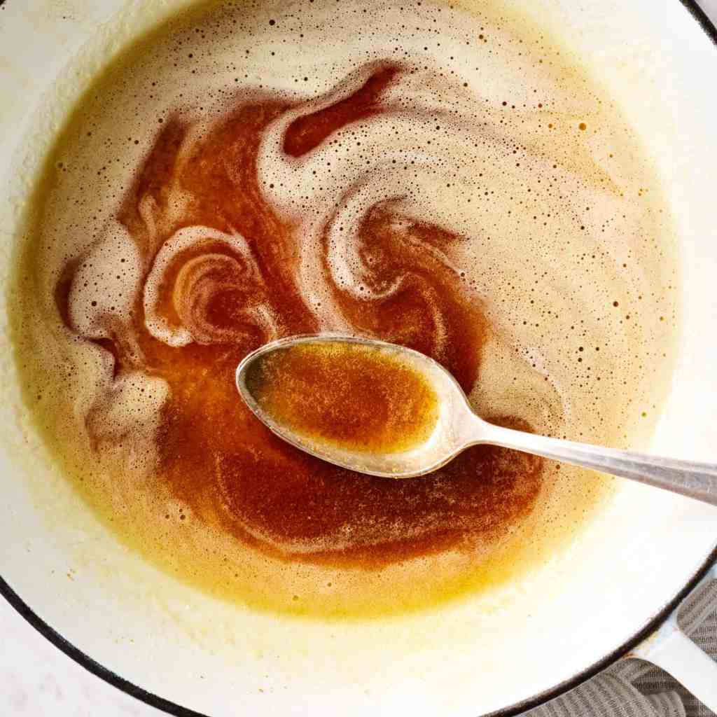 Brown butter in a saucepan with golden bits at the bottom