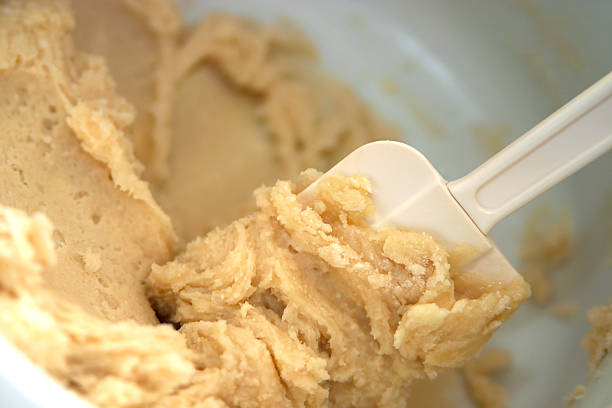 Dry ingredients being added to wet mixture in batches